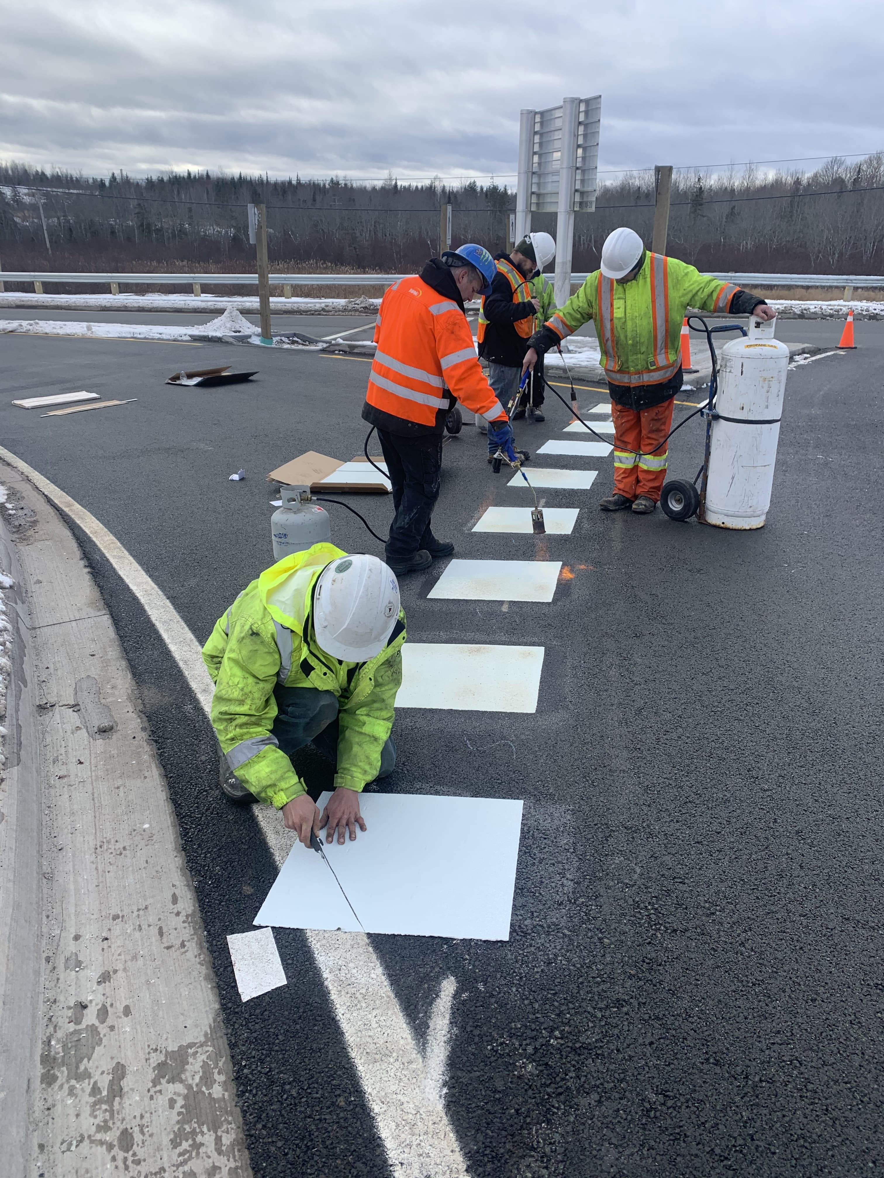 Crew installing thermoplastic markings